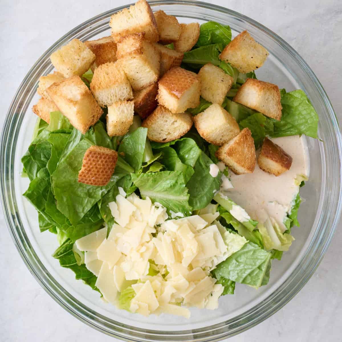 Salad ingredients in a large bowl before tossing together.